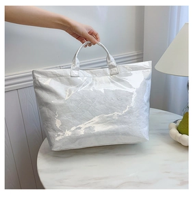 Silver metallic Tyvek tote bag with crinkle texture on white marble surface