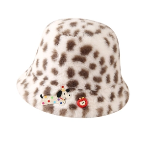 Leopard print plush bucket hat with cartoon dog and apple charms on white background