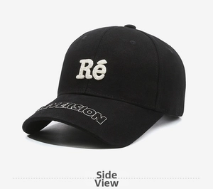 Detail of black cotton baseball cap with white 3D embroidery and side logo stitching