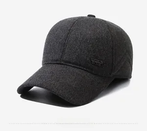 Détail de la casquette d'hiver en tissu gris texturé avec plaque métallique latérale