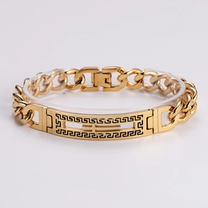 Detail of gold-plated stainless steel Cuban link bracelet with Greek key cutout pattern