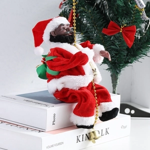 Detail of Black Santa Claus figurine in plush suit with golden beads and green gift bag