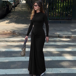 Chic black slim-fit maxi dress featuring a cinched waist and elegant long sleeves