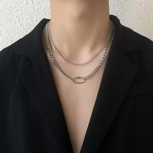 Detail of silver layered carabiner necklace with oval screw clasp on Cuban chain