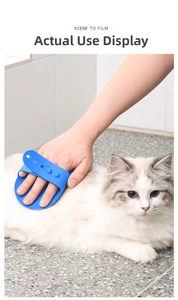 Close-up of blue silicone pet bath brush grooming a long-haired cat with adjustable strap