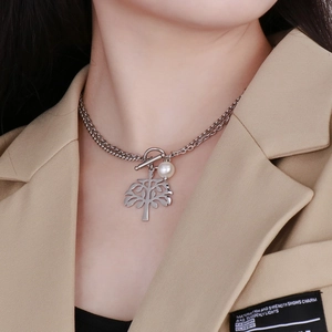 Detail of silver double-layered tree of life necklace with T-bar clasp and pearl
