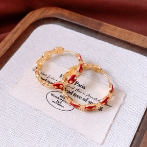 Detail of 18k gold plated hoop earrings with red heart enamel and micro-pave zircons