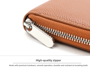 Detail of high-quality silver metal zipper on brown pebble leather wallet with smooth slider