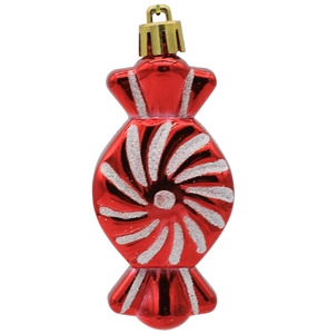 Detail of red candy-shaped Christmas ornament with white glitter swirls and golden loop