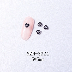 Macro detail of silver heart-shaped nail charms with metal edging, size 5x5mm