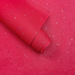 Close-up of red glitter pear paper with laser sequins for floral and gift packaging