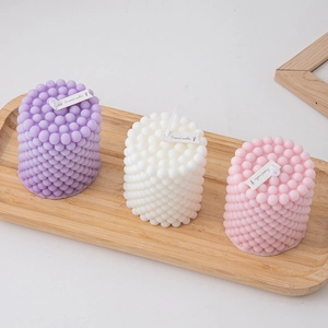 Minimalist bubble cube scented candles in purple white and pink on wooden tray