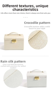 Close-up of beige PU leather jewelry box showing crocodile and silk grain textures