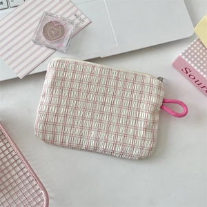 Detailaufnahme der rosa-weiß karierten Minitasche mit Crinkle-Textur und Reißverschluss
