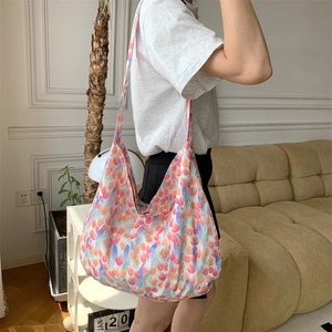Large capacity canvas shoulder bag with colorful tulip print shown on a model outdoors