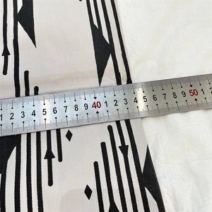 Detail shot of boho geometric fabric width measuring 45cm with a metal ruler