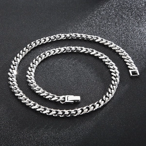 Close-up of polished silver titanium steel Cuban chain necklace with a secure clasp