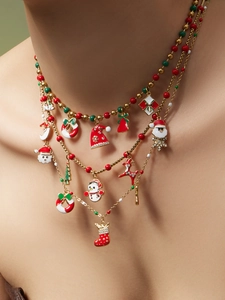Close-up of festive three-layer Christmas necklace with Santa, reindeer and bell charms