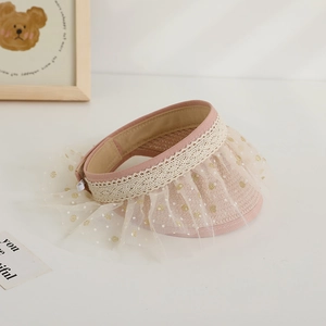 Detailed view of pink straw sun hat with gold polka dot tulle and delicate lace trim