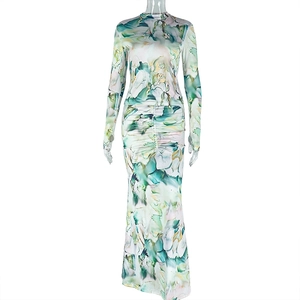 Detail of teal abstract print long sleeve slim fit maxi dress with ruched draping texture
