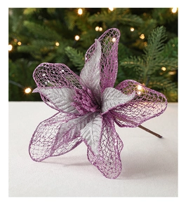 Detail of purple and silver glitter mesh Christmas flower with warm tree lights background
