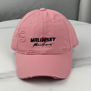 Close-up of pink distressed cotton baseball cap with Malinsky embroidery and ripped detail