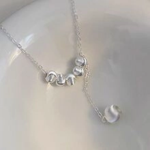 Macro detail of S925 sterling silver perfume bottle pendant with shimmering cubic zirconia