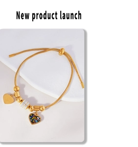 Detail of adjustable gold slider bracelet featuring colorful crystal heart charms