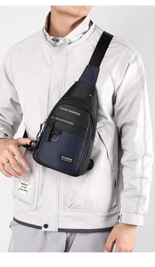 Detail of blue and black business sling bag with adjustable strap and dual zippers