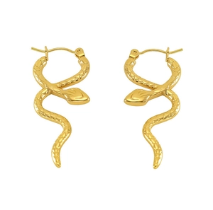 Detail view of golden snake earrings with intricate scale texture and curved design