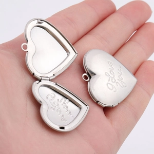 Detailed view of open and closed heart lockets with 'I Love You' engraving on palm