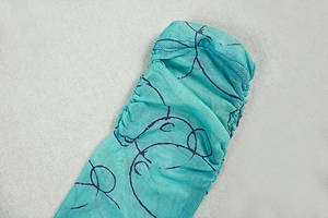 Detail of teal mesh dress featuring cartoon print and elastic cuff stitching