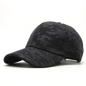 Detail of classic black washed baseball cap with durable ribbed fabric and six-panel crown
