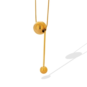 Minimalist gold snake chain necklace with round bead and vertical tassel pendant