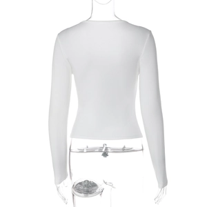 Detail view of the back of white long sleeve slim fit top with lace trim and ribbed texture