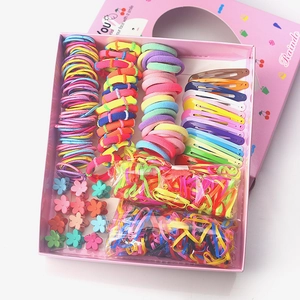 Pink gift box filled with colorful assorted hair clips, ties and floral claw clips for girls