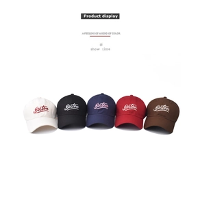 Detailed view of five cotton baseball caps with Boston embroidery in various colors