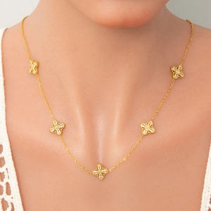 Detail of 18k gold plated stainless steel clover bracelet with sparkling zircon crystals