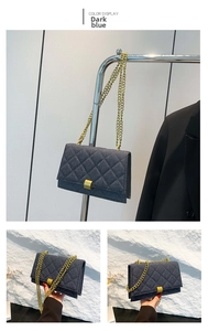 Detail view of dark blue denim chain bag with quilted patterns and golden hardware