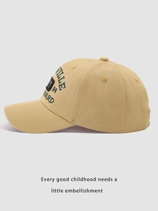 Close-up of khaki baseball cap featuring high-density green letter embroidery and fine stitching