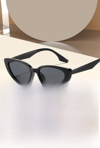Detailed view of black cat eye sunglasses featuring sleek glossy frames and UV lenses