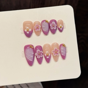 Pink and purple handmade press-on nails with 3D floral carving and golden beads
