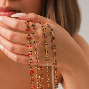 Gold cherry pendant necklace set with colorful enamel fruits in red, pink, and purple