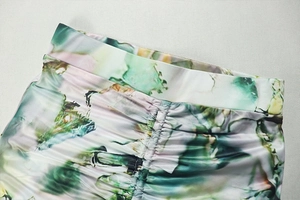 Detail of ruched waist design on long skirt with green and pink abstract ink print