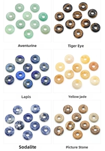 Macro display of diverse natural crystal agate donut pendants with authentic textures