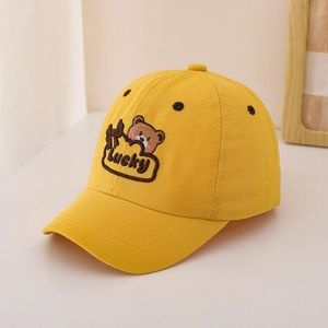 Detailed embroidery of a brown cartoon bear and Lucky text on yellow cotton baseball cap