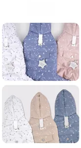 Detail view of winter dog jacket with star patterns and integrated metal D-ring for leash