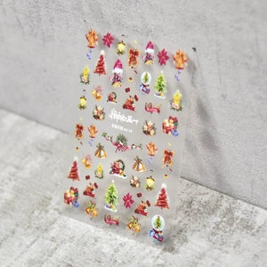 Japanese Christmas nail stickers featuring hand-drawn trees and bells on grey background