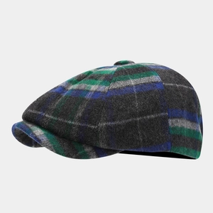 Detail shot of the vintage plaid newsboy cap showing wool blend texture and stitching