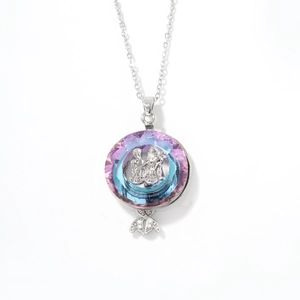 Silver coin necklace with gradient crystal ring and mermaid tail pendant on white background